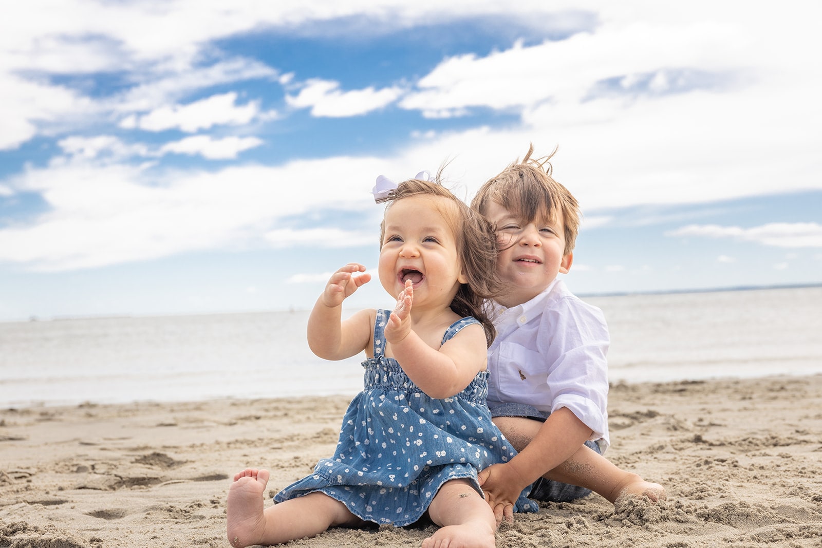 Lindsay Doyle's children sittig on beach together